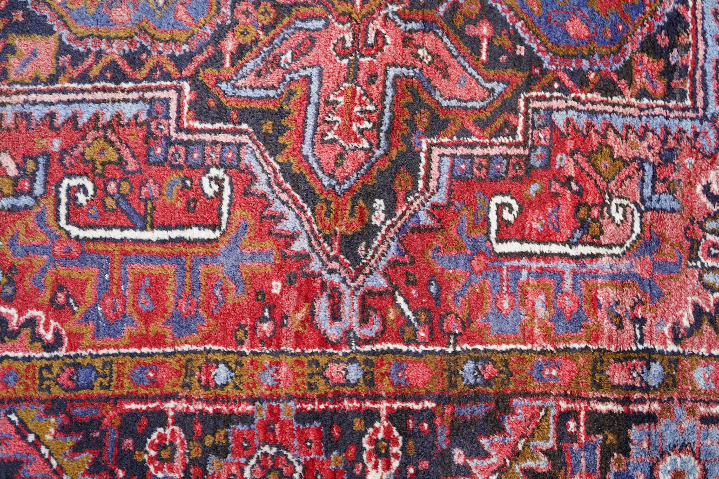 A Heriz brick red ground carpet